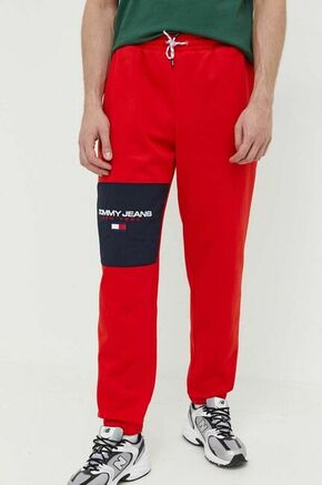 Spodnji del trenirke Tommy Jeans rdeča barva - rdeča. Spodnji del trenirke iz kolekcije Tommy Jeans. Model izdelan iz rahlo elastičnega materiala