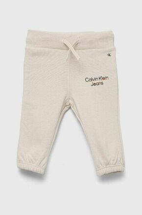Otroške trenirke Calvin Klein Jeans bež barva - bež. Spodnji del trenirke za dojenčka iz kolekcije Calvin Klein Jeans. Model izdelan iz pletenine. Model z mehko notranjo oblogo.