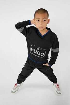 Otroške hlače HUGO mornarsko modra barva - mornarsko modra. Otroški hlače iz kolekcije HUGO. Model izdelan iz enobarvne tkanine.
