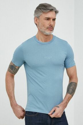Bombažna kratka majica Guess - modra. Oprijeta kratka majica iz kolekcije Guess. Model izdelan iz tanke